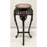 A Chinese hardwood jardiniere stand, shaped circular top with inset soapstone panel above a frieze