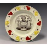 A 19th century pearlware commemorative plate, printed in monochrome with Queen Caroline, tomb,