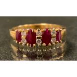 A diamond and ruby ring, liners set with four oval graduated deep red rubies, each divided by