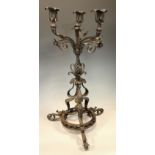 An elaborate Art Nouveau three branch candelabra, wrought and cast iron scrolling column, tripod