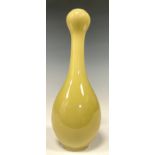 A Chinese monochrome baluster garlic head vase, glazed in pale yellow, 17.5cm high, double circle