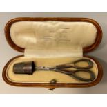 A cased thimble and scissors sewing set, 12.5cm long.