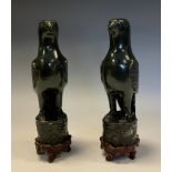 A pair of Chinese hardstone carvings, of parrots, hardwood bases, 25.5cm high overall, early 20th