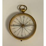 A Georgian gilt cased compass, white dial, black sixteen point scale, locking slide gilt case, 4cm