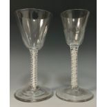 A George III cordial glass, faceted conical bowl, double helix white and clear air twist stem,