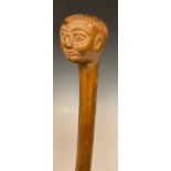 A 19th century folk art walking stick, the pommel boldly carved as the head of a man, 99cm long