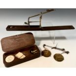 A George III apothecary scale, in a mahogany case, c.1800; a travelling guinea scale, labelled