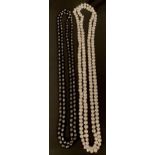 A long single strand cultured black pearl necklace, irregular deep tone black pearls, ranging