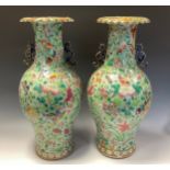 A pair of Chinese ovoid vases, decorated in polychrome enamels with birds, insects and flowers on