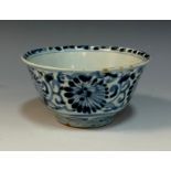 A Chinese bowl, naively decorated in underglaze blue with stylised flowers and scrolls, 14cm diam