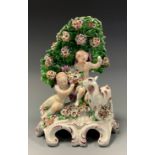 A Derby porcelain figure group, Cherubs feeding a Goat, beneath blossoming tree, 21cm high,
