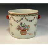 A Chinese export cylindrical ice pail, painted in polychrome with swags and baskets of flowers, mask