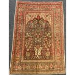 A Persian Hadjalili Tabriz rug, hand-knotted with stylised birds and flowering stems within an