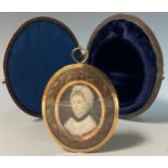 A 19th century oval portrait miniature mourning pendant, central panel of a lady, within hairwork