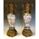A pair of Chinese baluster Mandarin vases, typically painted in polychrome and gilt, European