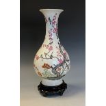 A Chinese baluster vase decorated with birds amongst flowering prunus