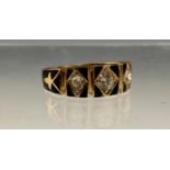 A Victorian diamond and black enamelled ring, panelled shield crest set with three old brilliant cut