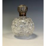 A Victorian silver mounted hobnail cut globular glass scent bottle, screw-fitting cover chased
