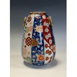 A Japanese porcelain ovoid vase, decorated in the Imari palette and underglaze blue, 15cm high,