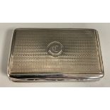 A George III silver rounded rectangular snuff box, engine turned overall, hinged cover, gilt