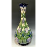 A Moorcroft 'Wolfsbane' vase by Anji Davenport, stylized with tube lined violet flowers on graduated
