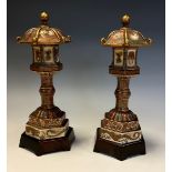 A pair of Japanese Satsuma models, of pagoda shaped lanterns, finely painted and picked out in
