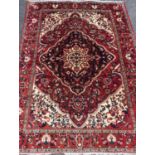A Persian Tabriz rug, knotted with a central lotus-form medallion within navette-shaped field of