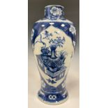 A Chinese baluster vase, painted in tones of underglaze blue with table sets with censers,