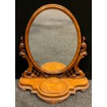 A Victorian carved mahogany toilet mirror, oval plate, carved and pierced stanchions, shaped base