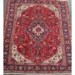 A North West Persian Heriz carpet, hand-knotted with a central diamond-form medallion, within a