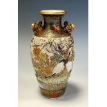 A Japanese satsuma ovoid vase, painted with cranes amongst blossoming prunus, 14.5cm high, character
