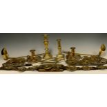 A pair of 18th/19th century brass chambersticks, ejector socles, dished drip pans, rolled thumb