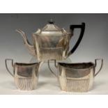 A Victorian silver three piece tea set, ebony handled teapot, sugar bowl and milk jug, Martin,