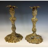A pair of rococo gilt bronze table candlesticks, cast throughout with flowers and scrolls, 28.5cm