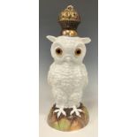 A 19th century continental porcelain oil lamp, as a standing Owl, with bulbous glass eyes, white