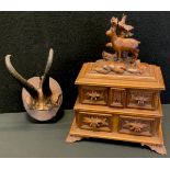 A Black Forest walnut two-tier jewellery box, carved to top with a Chamois standing on a rocky