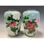 A pair of Japanese cloisonne enamel ovoid vases, decorated in polychrome with roses on a pale blue