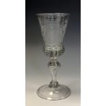 A large 18th century wine glass, engraved with Royal coat of arms, folded foot, 22.5cm high