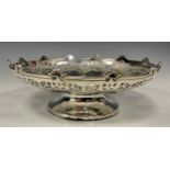 A silver shaped circular pedestal sweet meat bowl, the undulating sides with stylised flowerheads