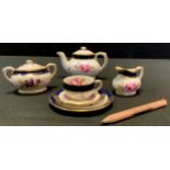 A Coalport Miniature Pink Rose pattern bachelor tea set, comprising teapot, sugar bowl, milk jug,