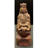 A late Qing period Chinese carved gilt wooden figure, Guanyin seated crossed legged, wearing a