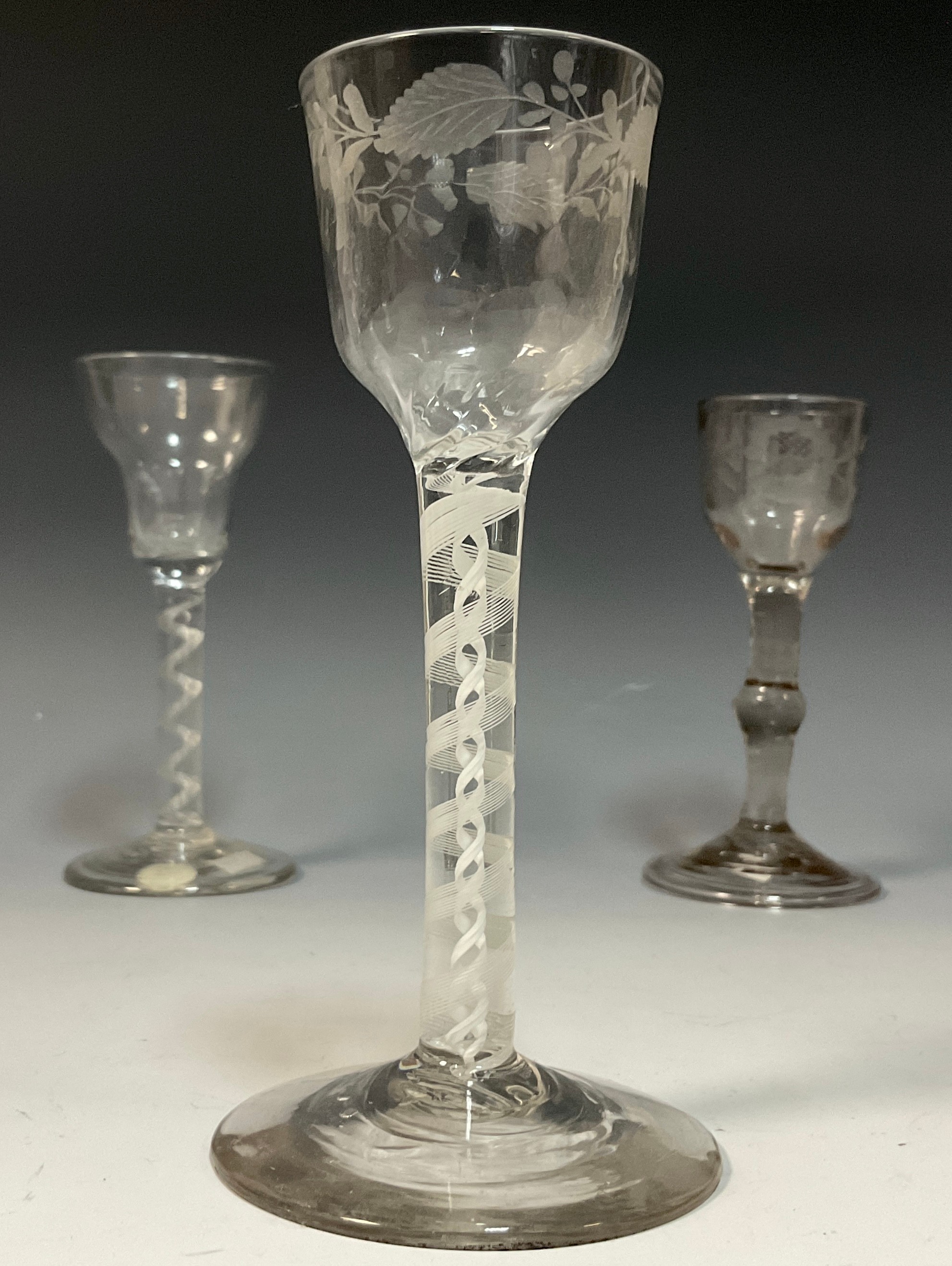A George III cordial glass, the small bucket shaped bowl engraved with stylised flowerheads, - Image 2 of 3