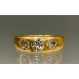 A Victorian diamond ring, set with three rubover set old cut diamonds, total estimated diamond