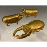 Two Victorian novelty brass so-to-bed vestas, each in the form of a pig, 5cm long; another vesta