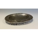 A Chinese silver oval dish, engraved and pierced with dragons amongst scrolling clouds, fluted bun