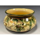 A Doulton Lambeth Faience fruit Bowl, painted by Mary Capes with Honeysuckle and a cream and green