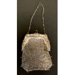 An Art Nouveau silver mesh evening purse, the mount chased with stylised flowers and leaves, 16.