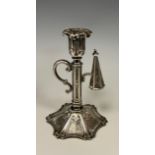 A Victorian silver Gothic Revival chamberstick, floral sconce, hexagonal column, scrolling handle,
