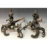 A pair of Louis XV Rococo bronze chenets, scrolling fronts, iron bar returned, approx 30cm high,