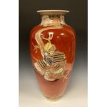 A large Japanese Satsuma ovoid vase, painted with figures on a cinnabar ground, 62cm high, Meiji